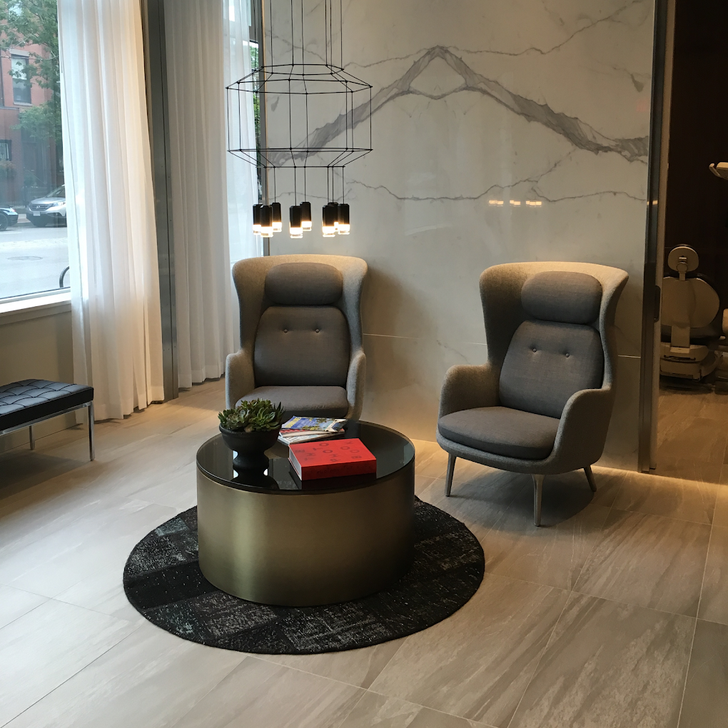 Waiting lounge, Fritz Hansen Ro armchairs facing a bronze drum coffee table on a Boston brownstone street
